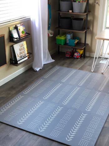 Reviewer's photo of the grey mudcloth print foam playmat in their kid's room