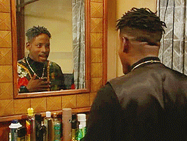 T.C. Carson playing Kyle Barker confidently looking at himself in the mirror. 