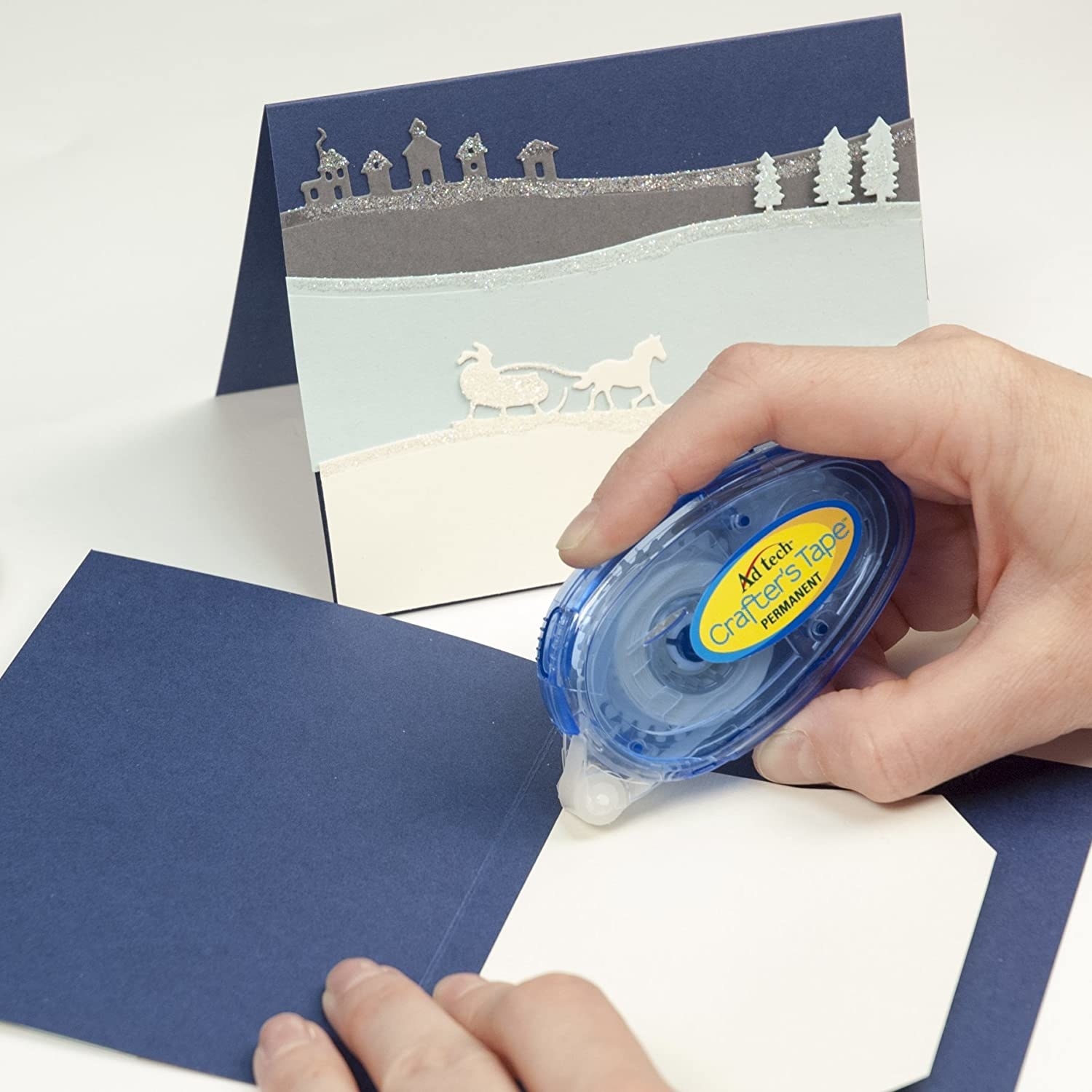 A person using the crafter&#x27;s tape on a card