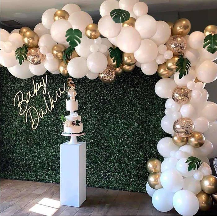 A balloon garland made from white and gold balloons