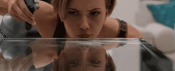 gif of actor Scarlett Johansson cleaning a glass table