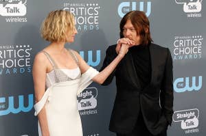 Reedus kisses Kruger's hand at an event