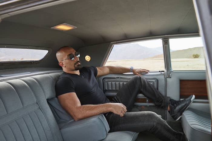 A man lounging in a luxury car