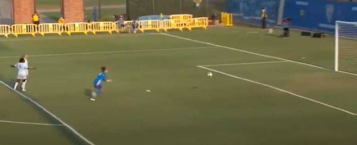 Soccer player chases down soccer ball