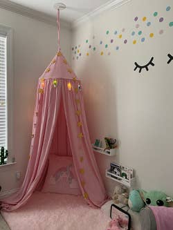 Reviewer's photo showing the pink canvas canopy nook in their kid's play space