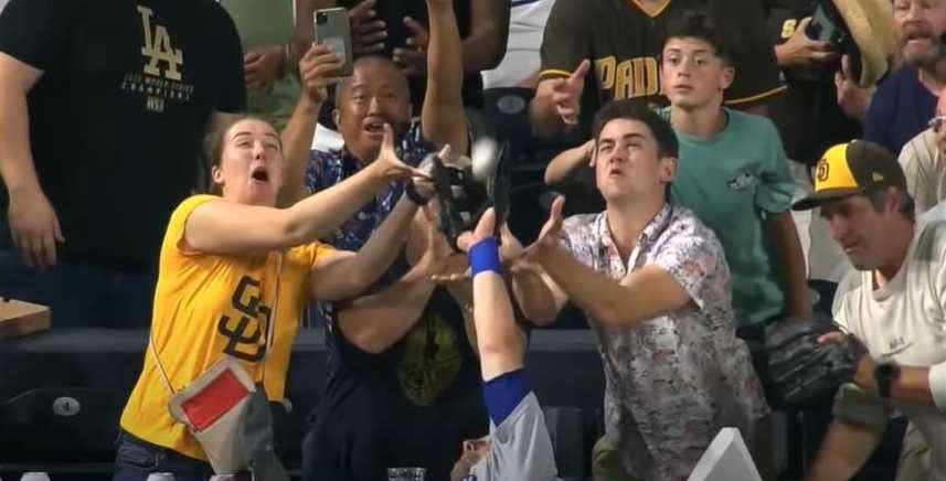 Baseball player reaches into crowd to steal the ball