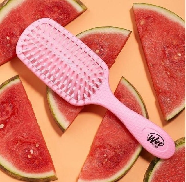 a pink wet brush on top of watermelons