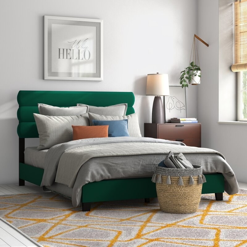 A bedroom featuring the bed in emerald