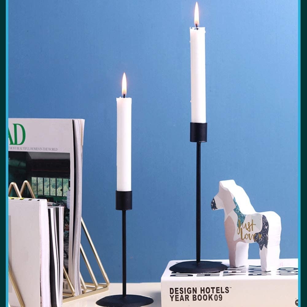 black candle holders on desk