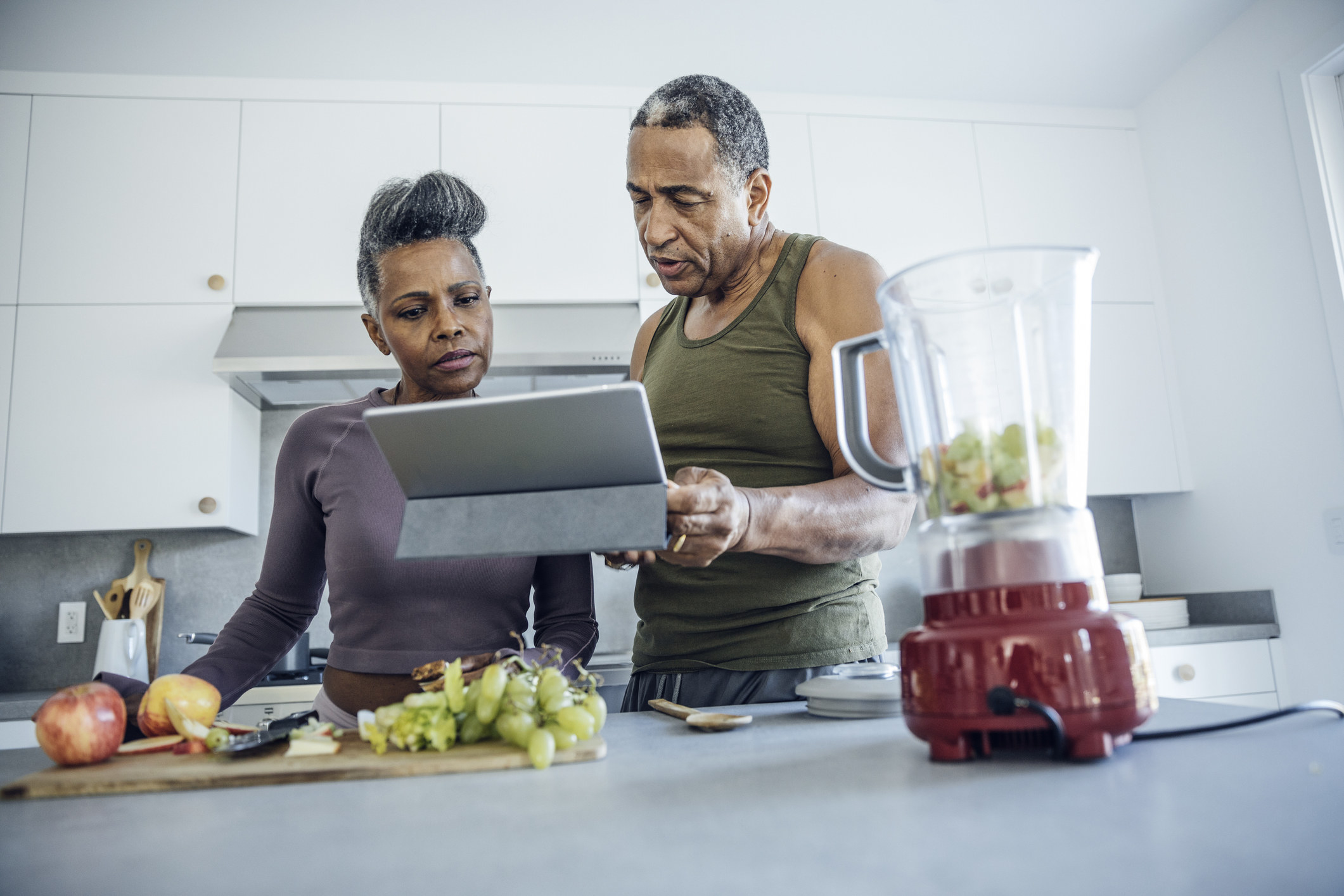 couple looking at their tablet in the kitchen