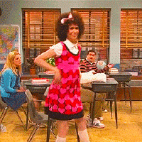 A gif of Kristen Wiig dancing silly in a classroom of shocked kids