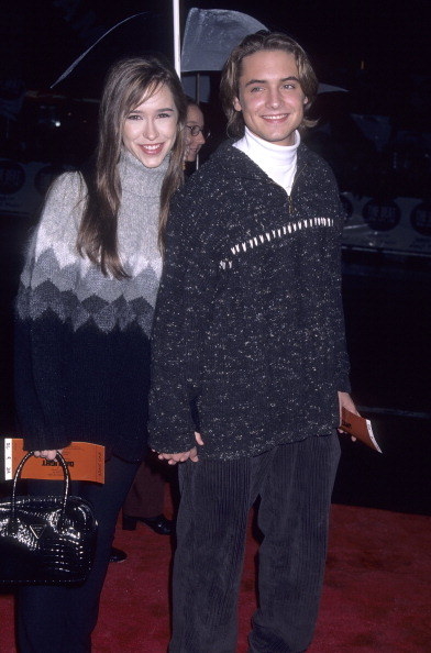 Jennifer and Will smiling and holding hands