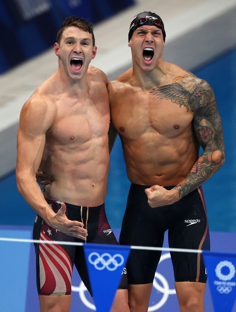 Two American swimmers cheering at the pool