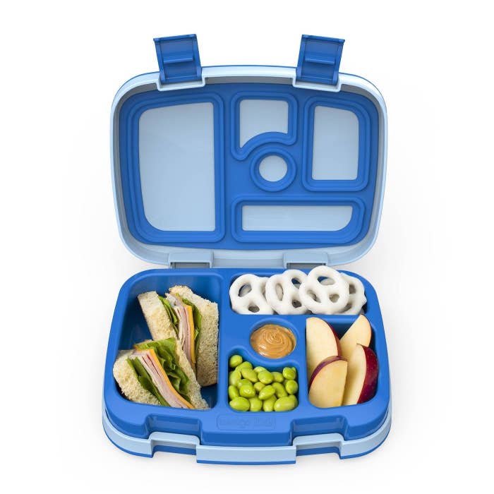 blue bento lunch box with sandwich and and other foods in separate compartments