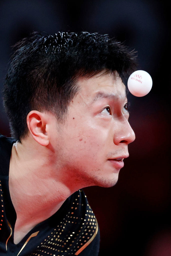 The athlete staring at the pingpong ball as it floats incredibly close to his head
