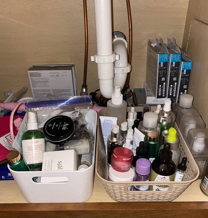 Photo of tons of makeup products under sink.