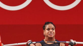 This weightlifter has a strained face as they attempt a lift