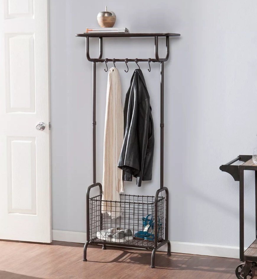 A rustic brown entryway storage rack with a shoe compartment and 5 hooks for coats, scarves, etc