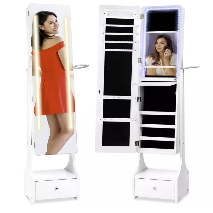 A full length armoire mirror that includes 4 makeup shelves, necklace and bracelet hooks, earring and ring holders, and a large bottom drawer for other beauty accessories or tools