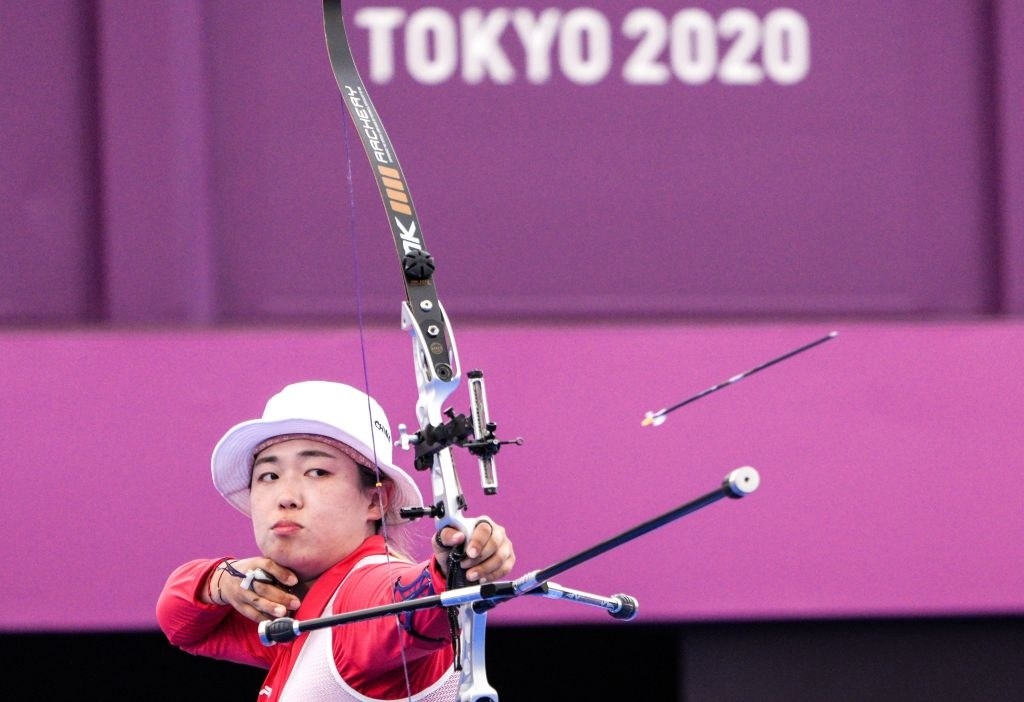 An archer releasing an arrow from their bow