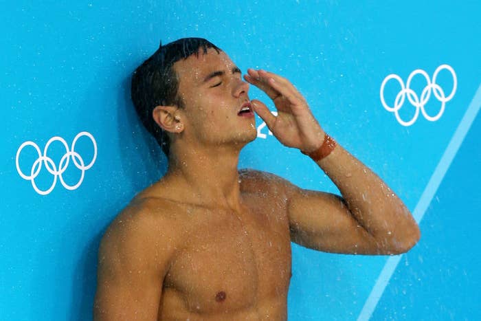 Tom Daley standing under the diver pool shower