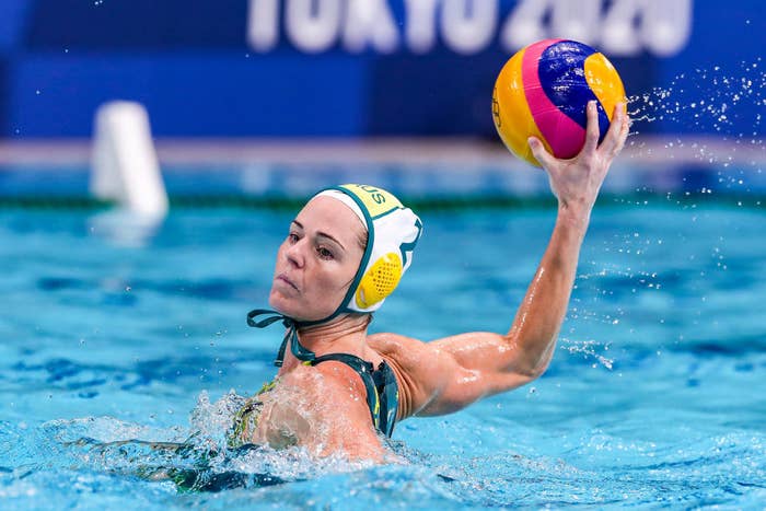 A water polo player wearing the cap and getting ready to throw the ball