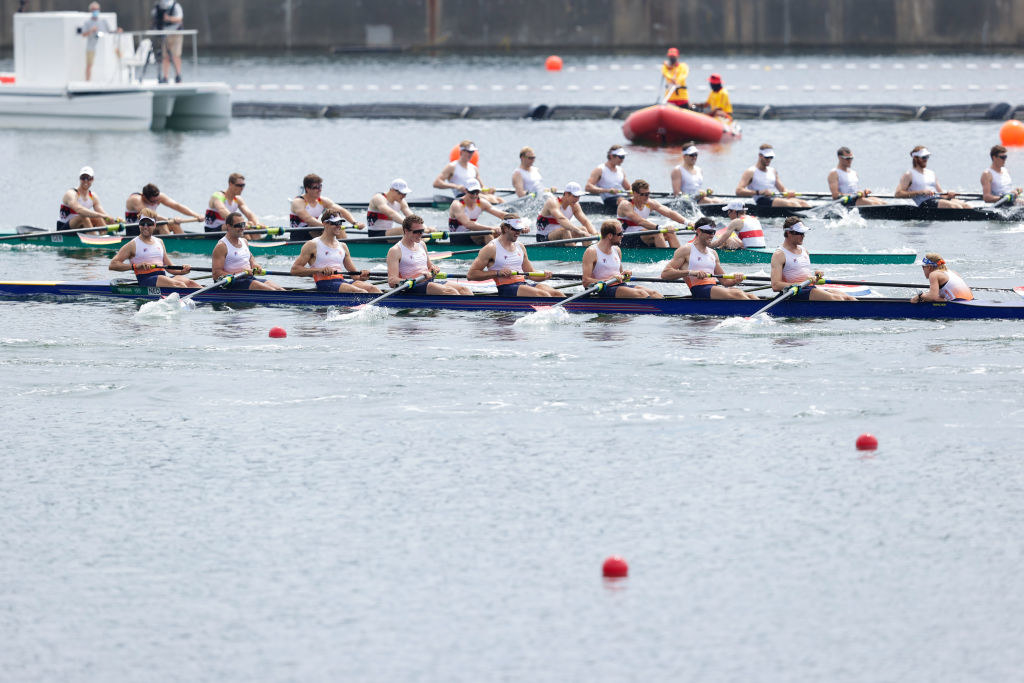 A rowing team with the coxswain sitting on the far right