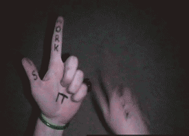 person holding up fingers with letters written on them that spell the words of the songs