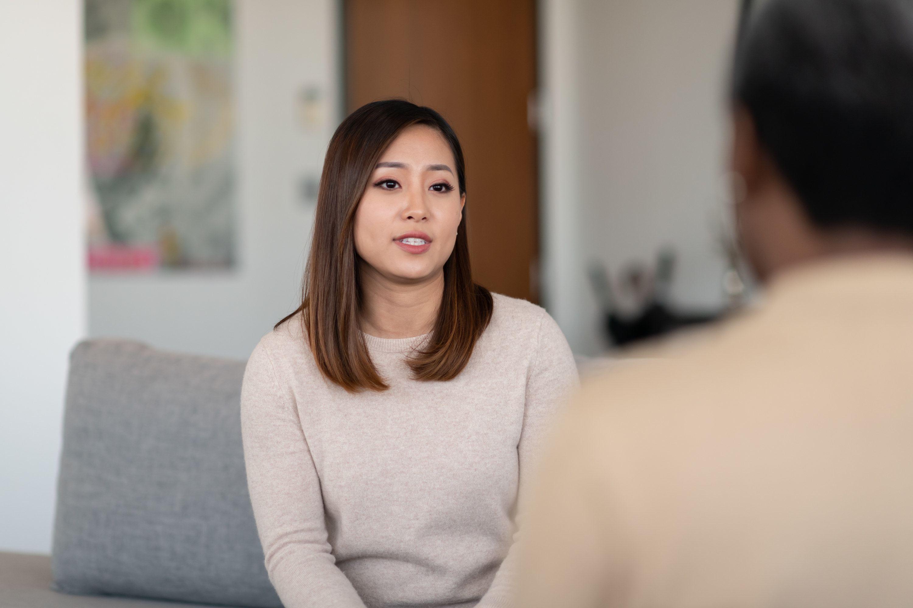 An Asian woman talks to a therapist