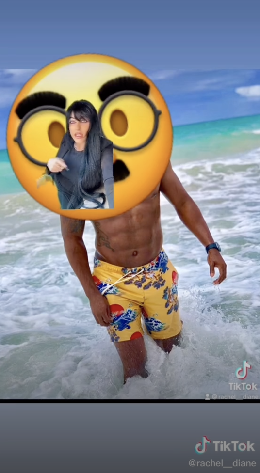 Rachel showing a picture of a man shirtless at the beach with his face covered