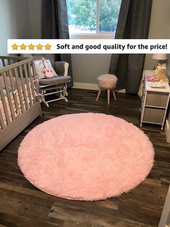 Reviewer's photo of the pink round shag rug in their nursery