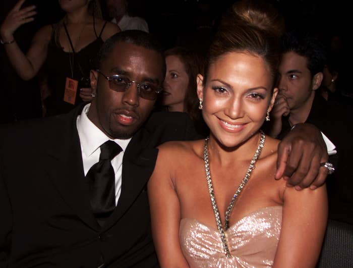 Diddy puts his arm around Jennifer while sitting at an award show