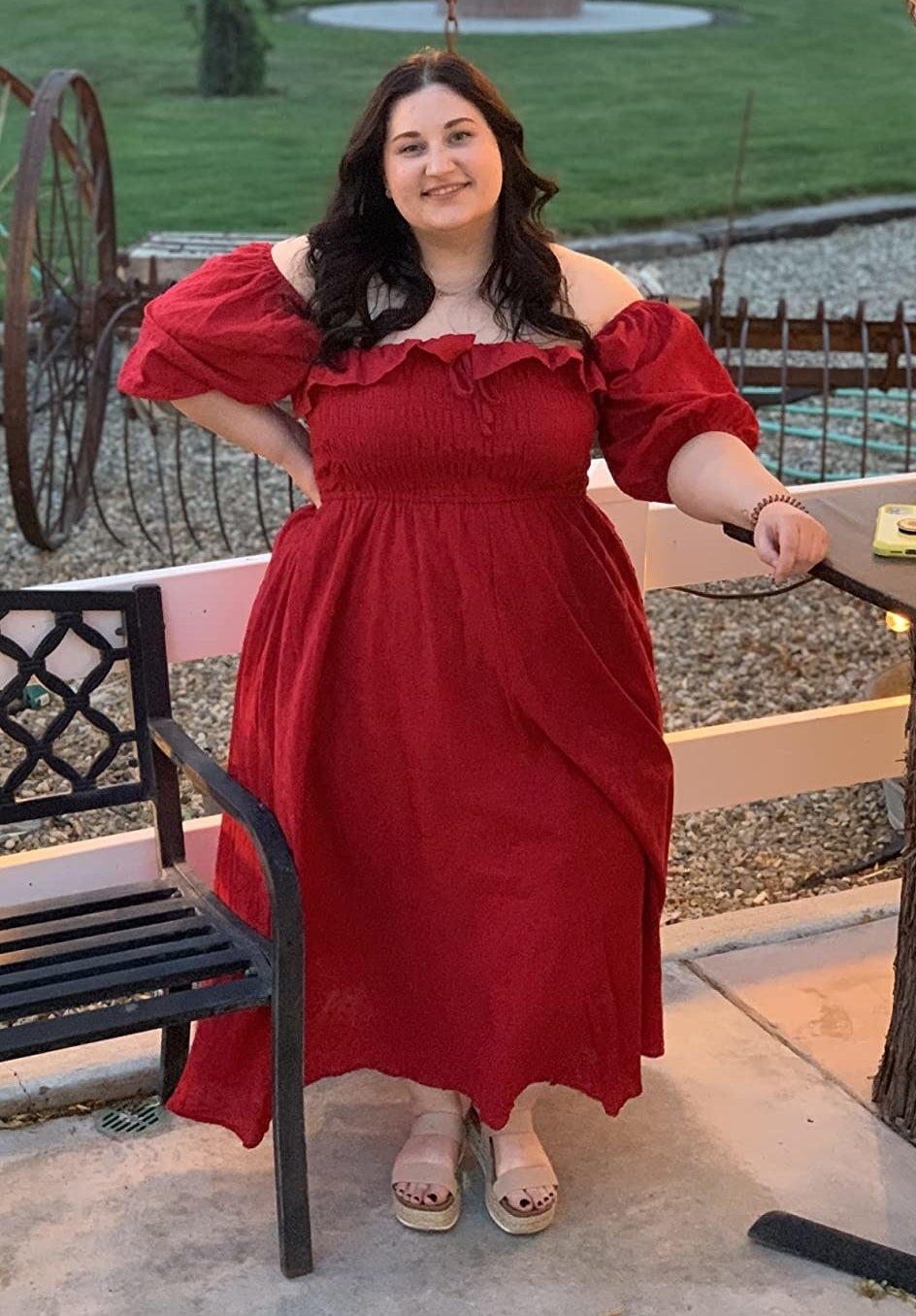 A reviewer wears the dress in red
