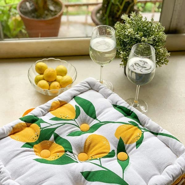 A floor pillow with a lemon print on it