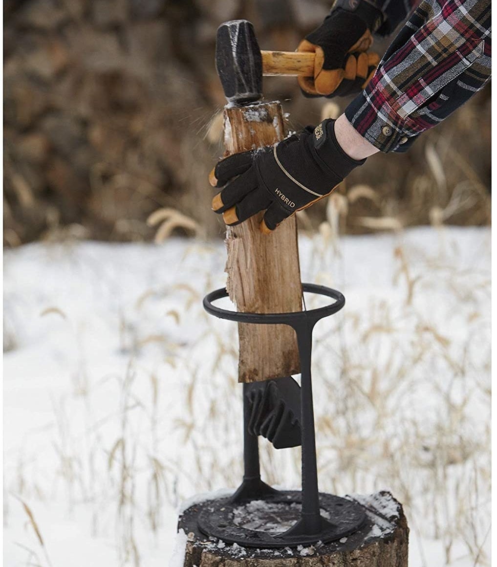 A person whacking a piece of wood in the holster with a hammer