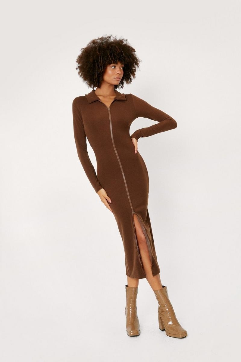model wearing ribbed mid-length polo dress with zipper all the way down the front in brown
