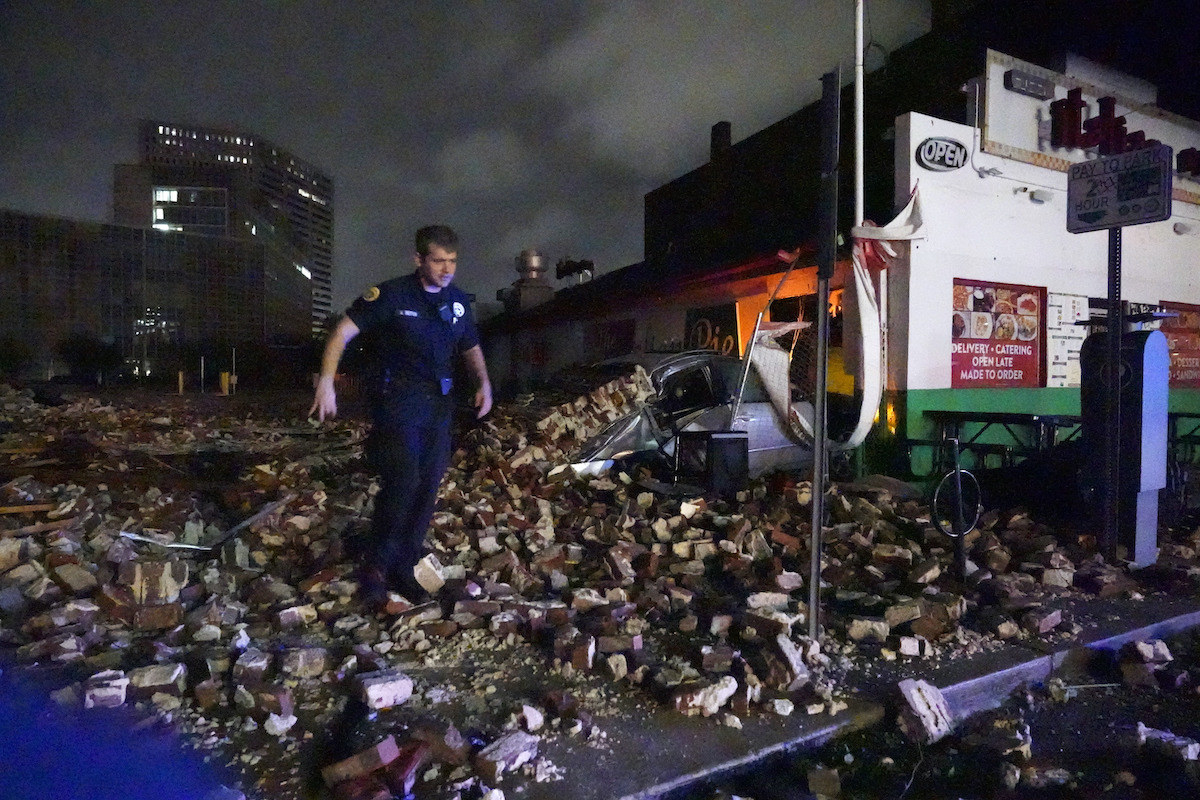 Police detective looks over debris from a building that collapsed during Hurricane Ida in New Orleans