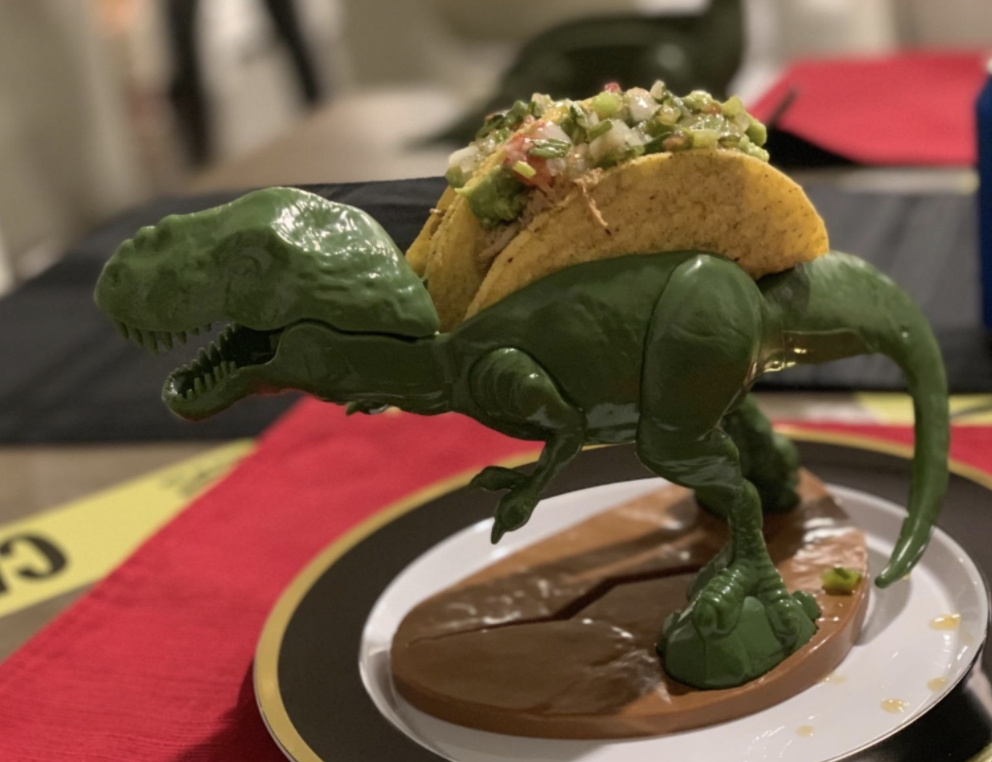 reviewer image of t-rex holding taco