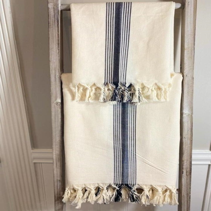 two tablecloths hanging from a ladder