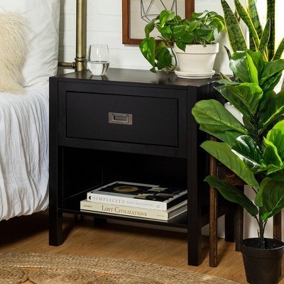 black side table next to a bed