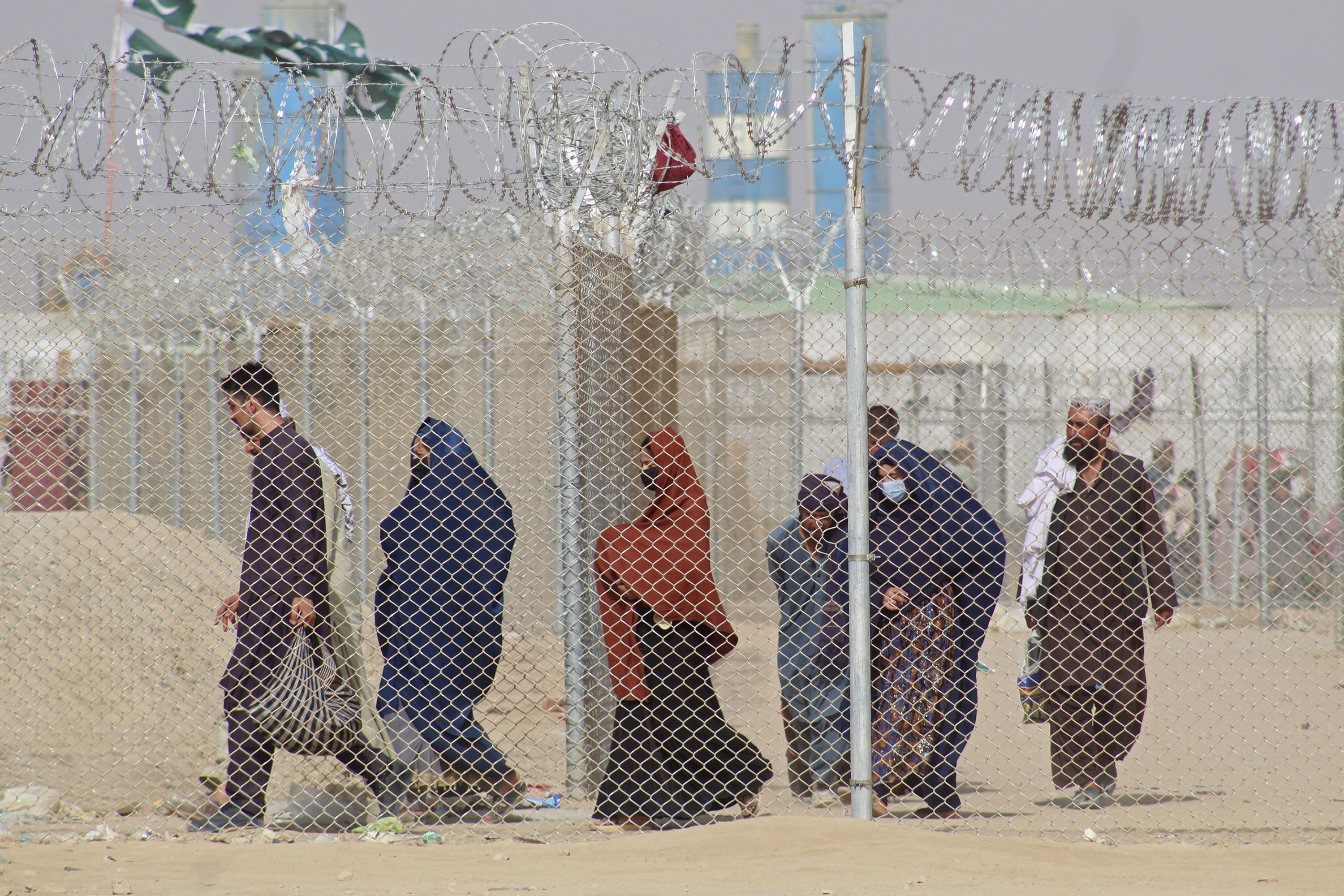 Afghan residents walk to a border station to leave for Pakistan