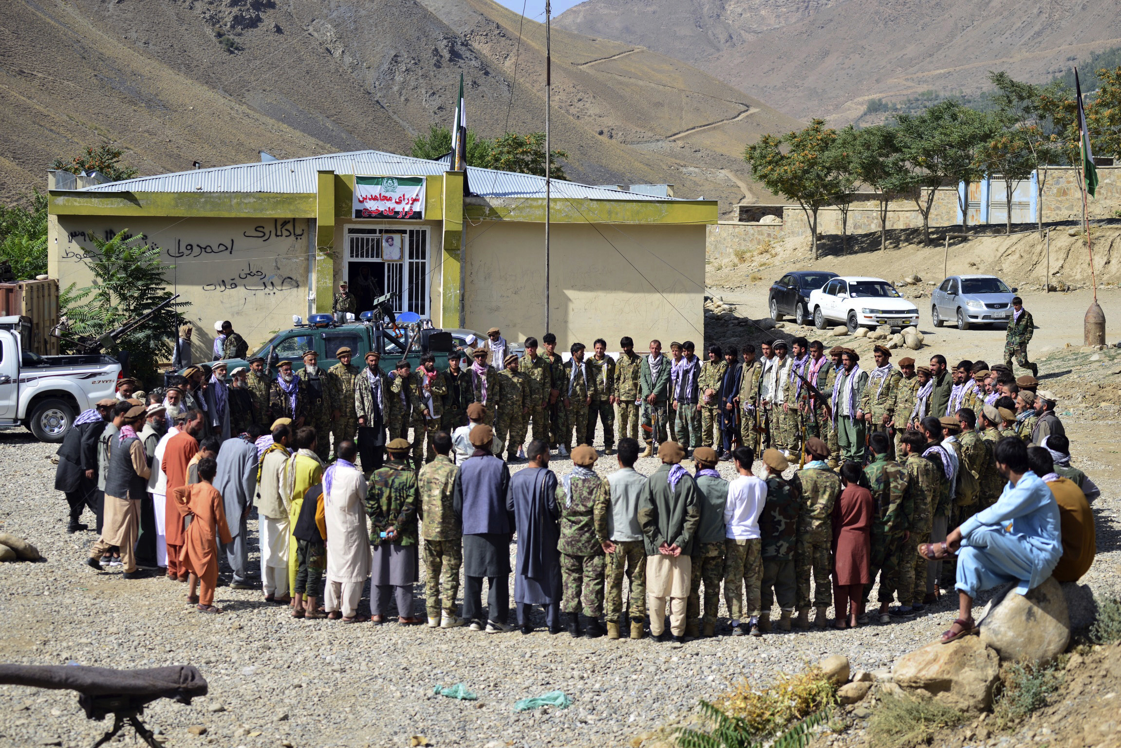 Anti-Taliban militiamen circle up outside as they take part in a training exercise