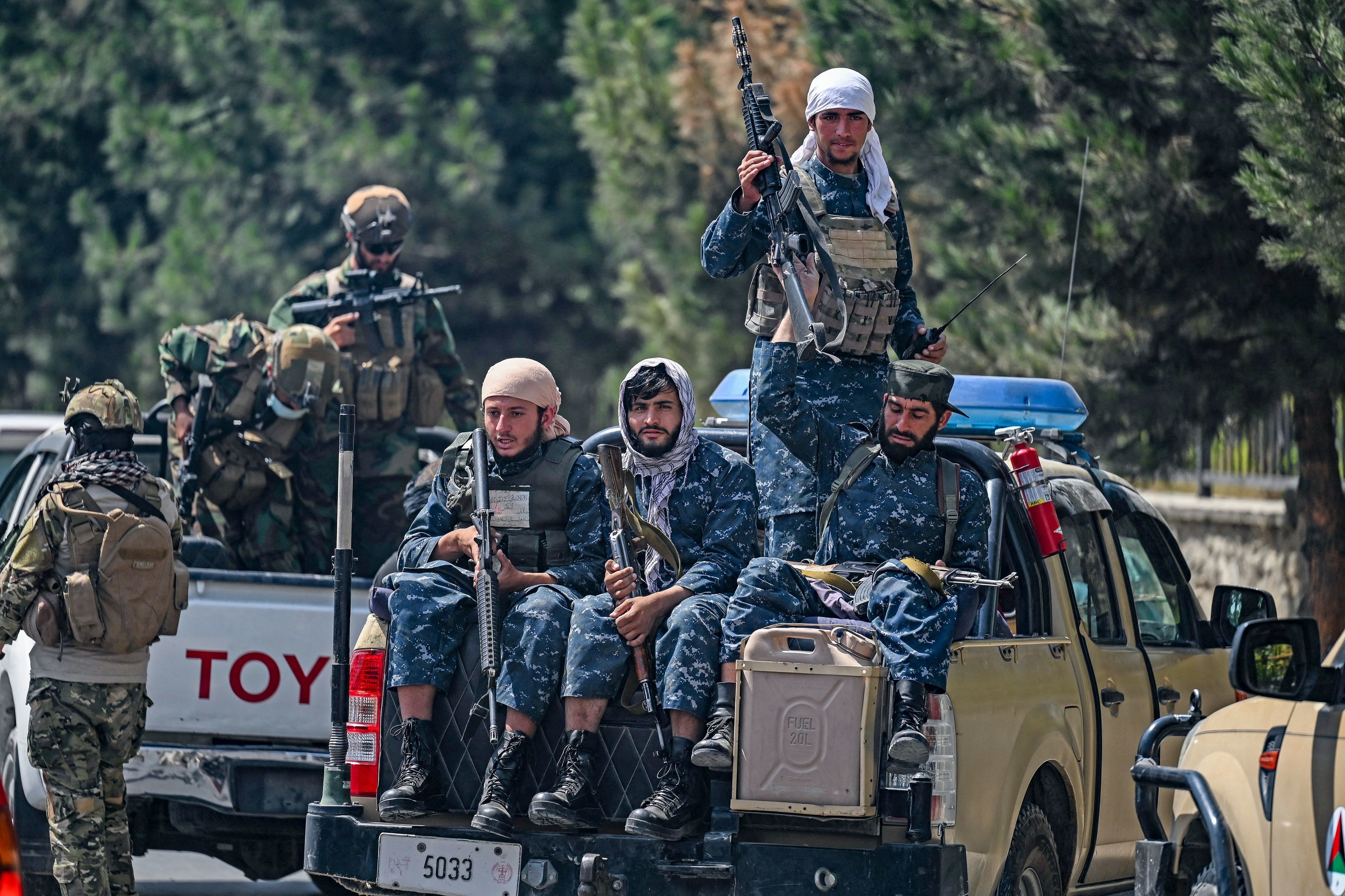 Taliban soldiers sit on a truck as they patrol Kabul