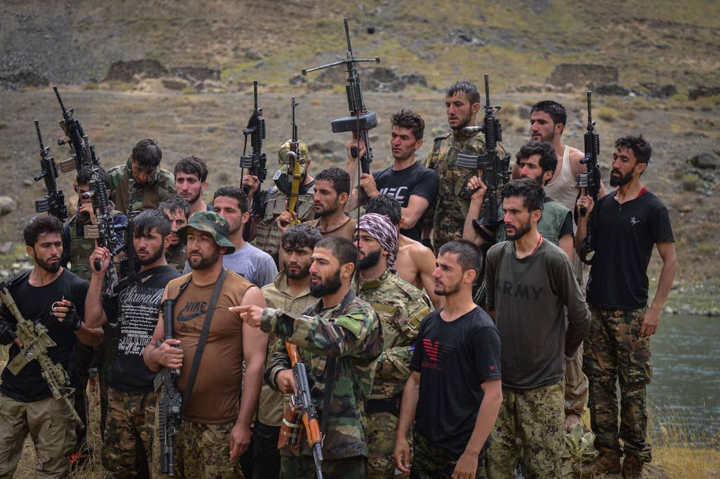 Taliban resistance soldiers hold guns and participate in a training