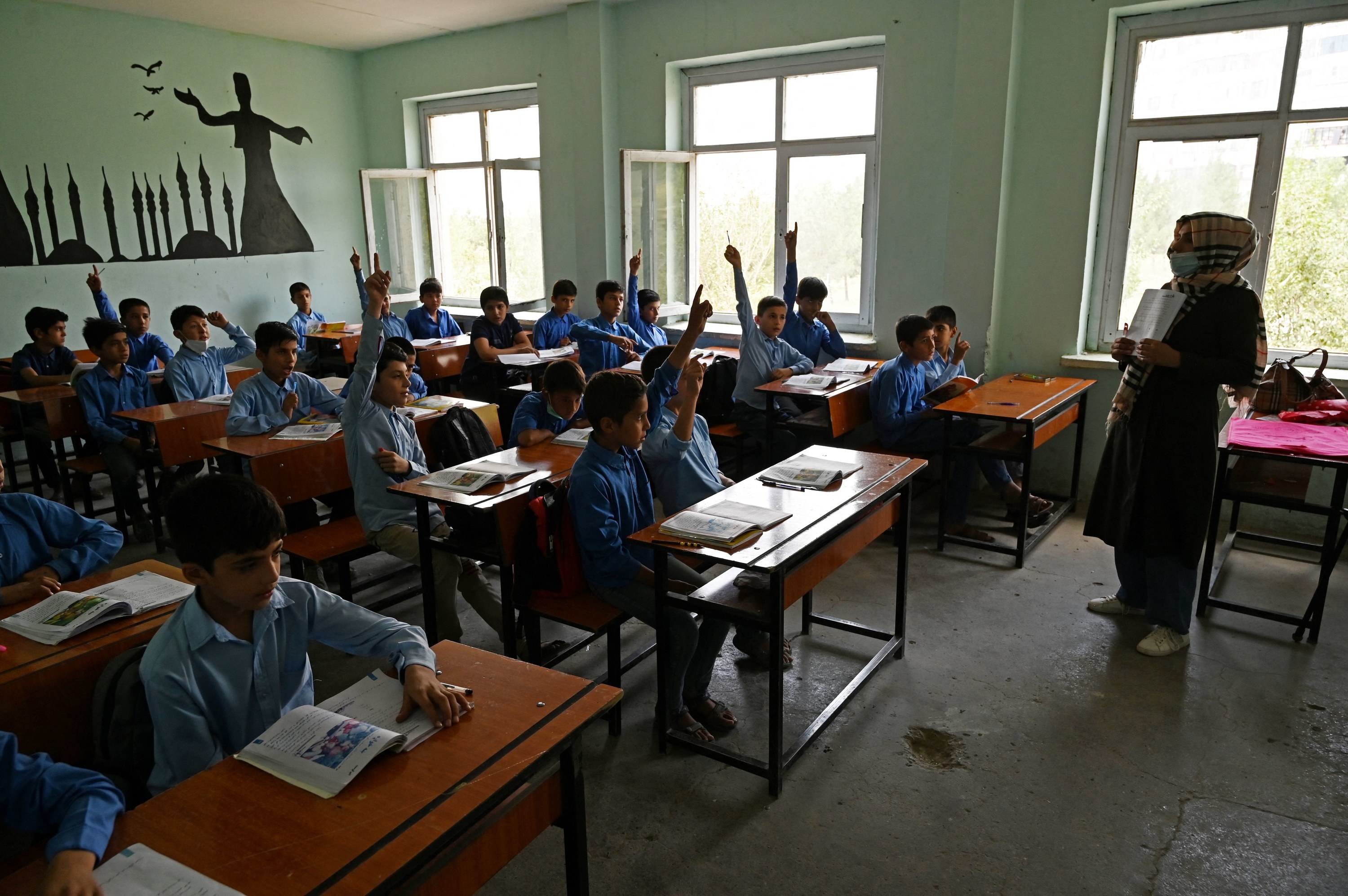 Afghan students participate in class at a middle school