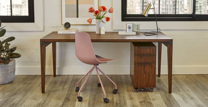 dusty pink office chair in front of a desk