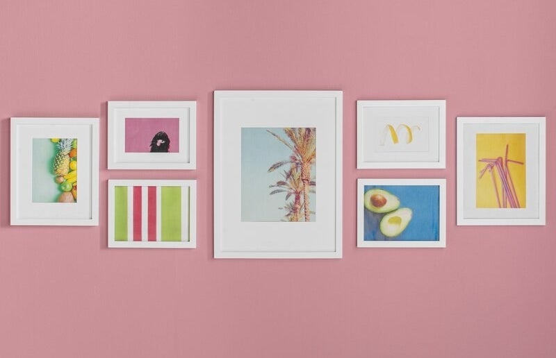 white frame gallery wall hung on pink wall