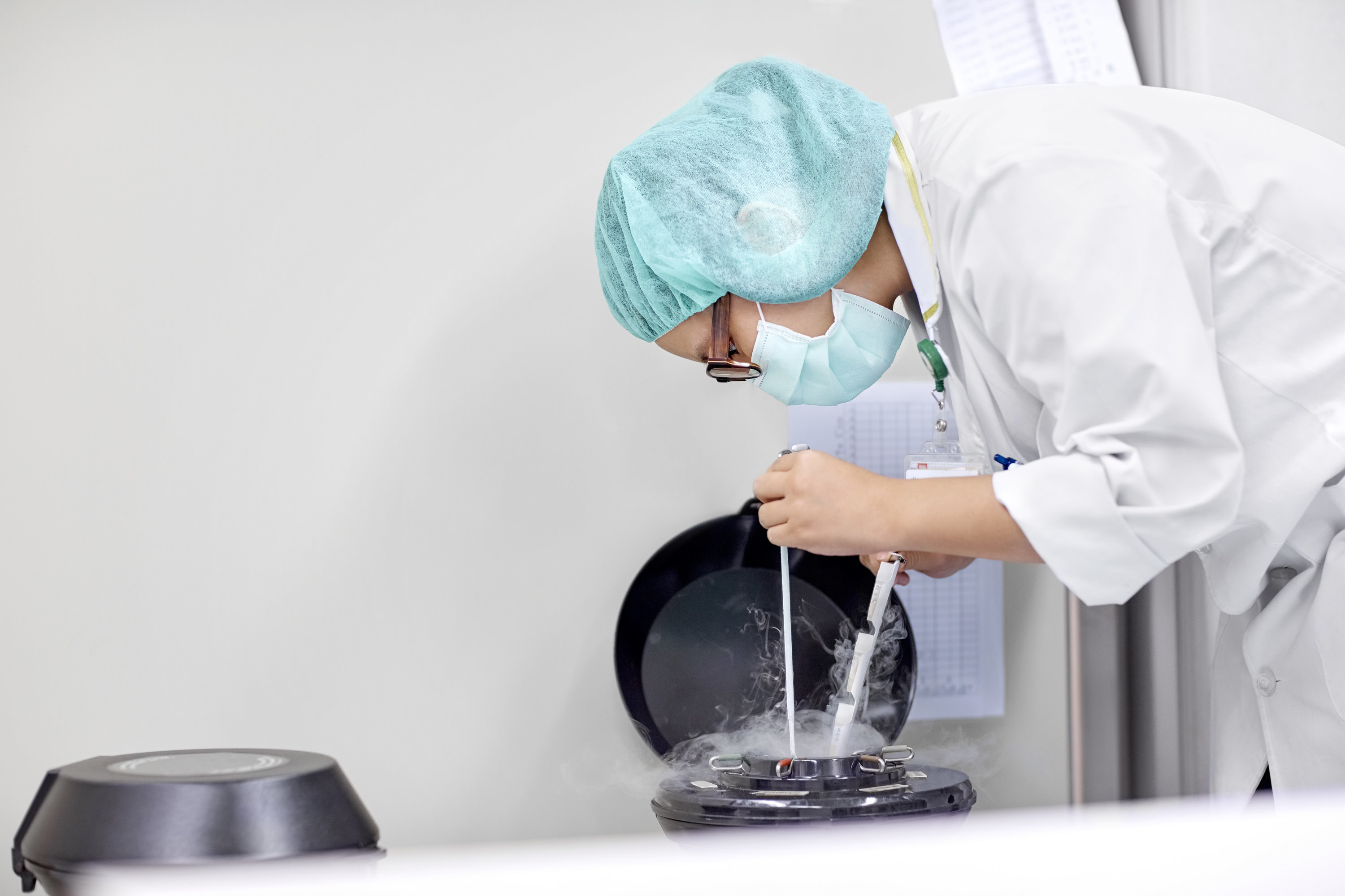 A doctor pulling eggs out of freezing chamber