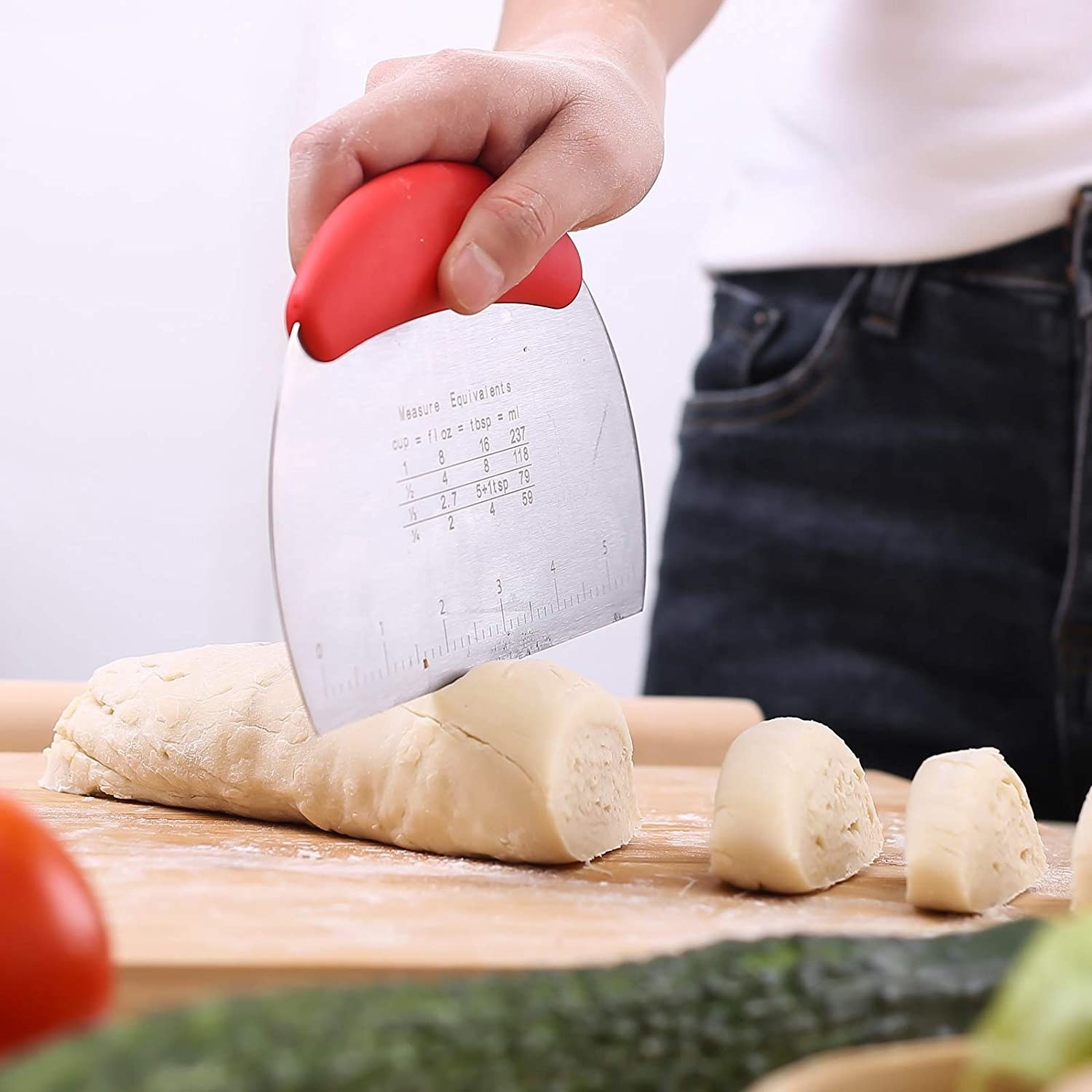 A person cutting dough with the tool