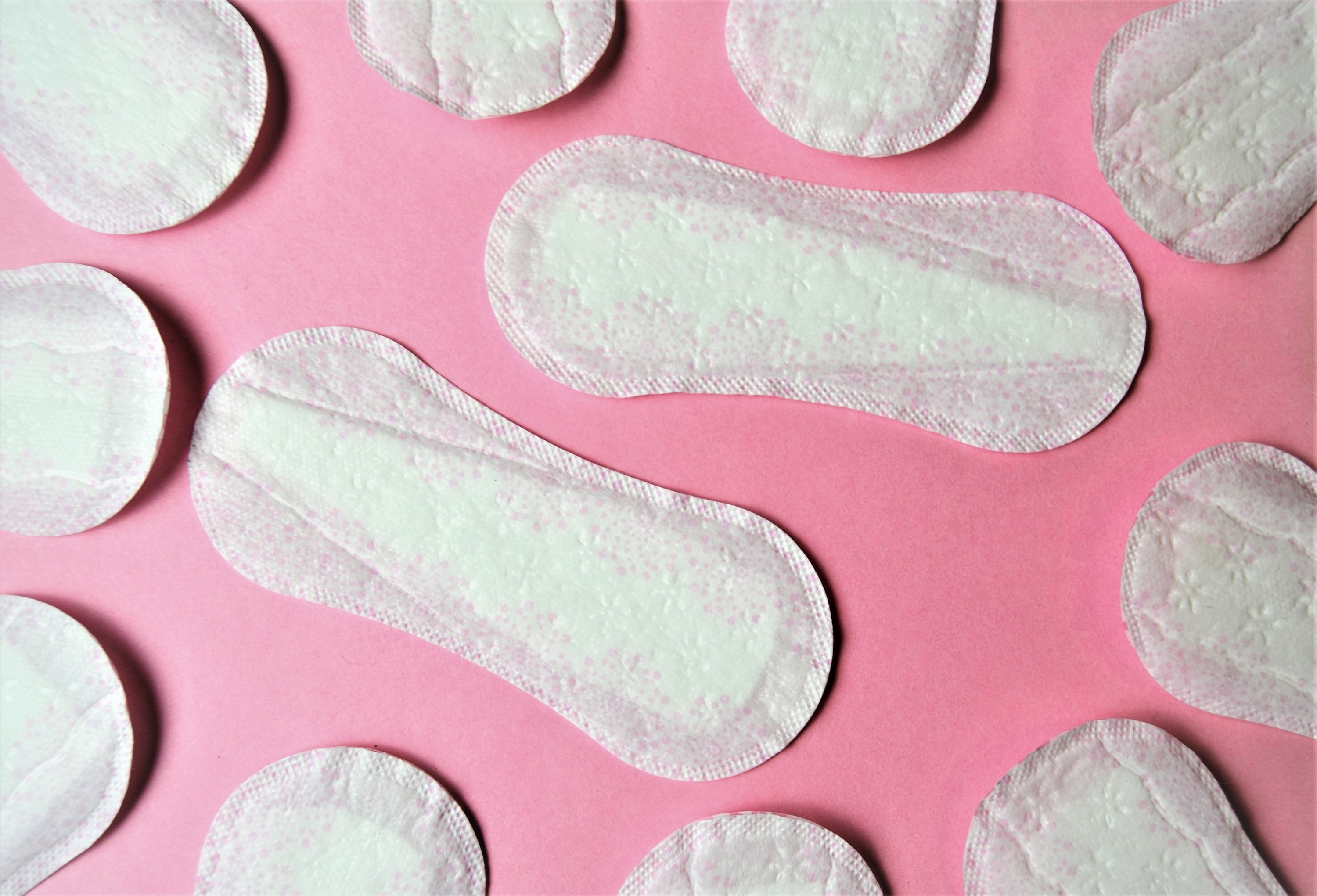 An image of menstrual pads on a pink background